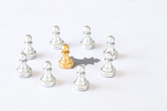 Business and leader concept,  chessmen with gold king chess shadow on white background.