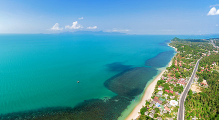 Aerial panoramic view of ocean, beach and blue cloudy sky, Koh Samui Island, Thailand