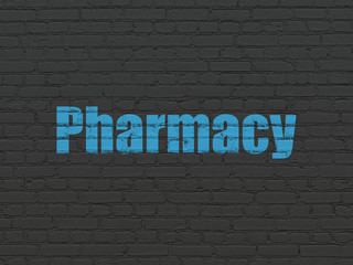 Fototapeta premium Medicine concept: Painted blue text Pharmacy on Black Brick wall background