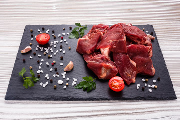 fresh lamb meat on a textured stone plate