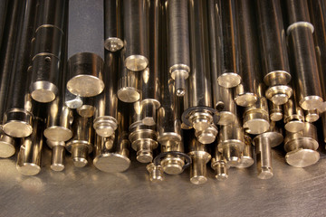 Shiny metal round bars and rods on steel background