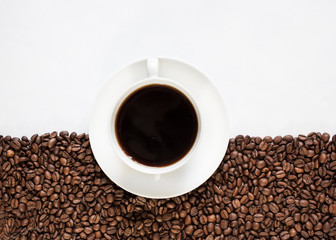 Coffee cup on half coffee beans and half white background