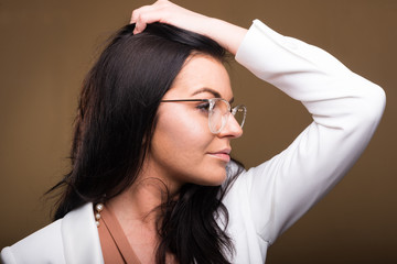 Side view of beautiful brunette business woman posing.