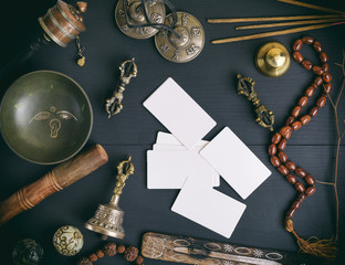 empty white business cards in the midst of Asian religious objects for meditation and alternative...