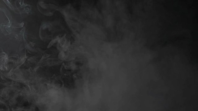 A cloud of white smoke emanating from the bottom of the frame and separating itself in two different parts in reverse as an abstract background
