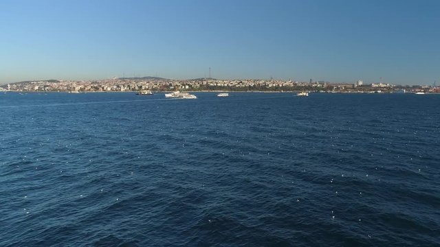 Ships floating Bosphorus blue water sunny day. Aerial drone view on sunset in Istanbul, Turkey
