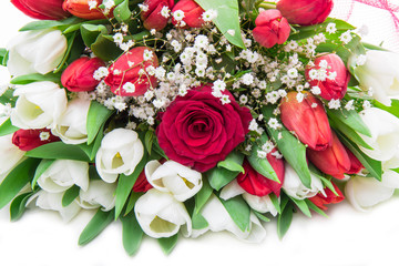 Fototapeta na wymiar beautiful bouquet of red and white tulip and one rose