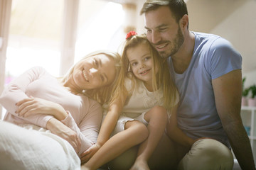 Young happy family enjoying at home.
