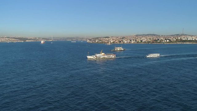 Ships floating Bosphorus blue water sunny day. Aerial drone view on sunset in Istanbul, Turkey