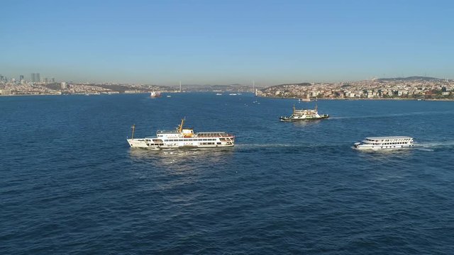 Ships floating Bosphorus blue water sunny day. Aerial drone view on sunset in Istanbul, Turkey