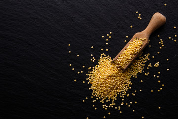 Fototapeta premium a bunch of millet on a dark rocky background