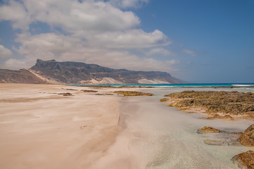 Fototapeta na wymiar A beautiful virgin beach, perfect sand and water and mountains. Paradise Island. 