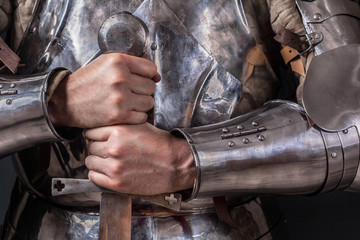 knight wearing armor and holding two-handed sword