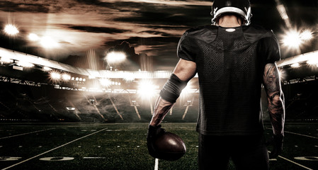 American football sportsman player on stadium. Sports banner and wallpaper with copyspace. © Mike Orlov