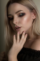 Beauty portrait of stylish blonde girl with professional makeup