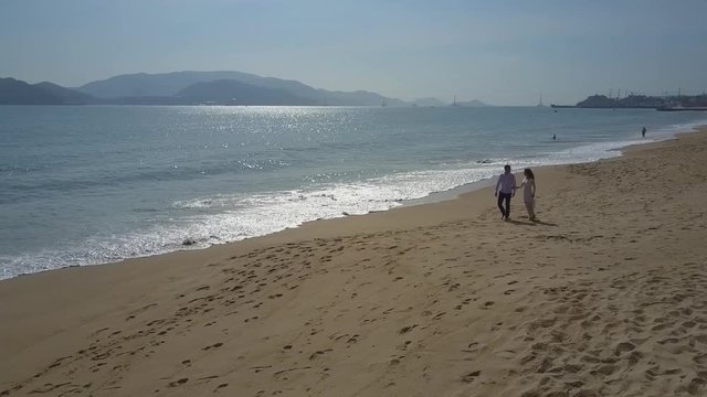 Man Woman Kiss on Beach against Endless Ocean