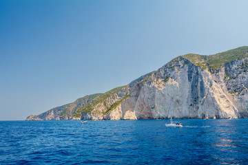 Fototapeta na wymiar Yacht driving across ionian sea close to beautiful sunny Hill of Zakynthos island, Greece