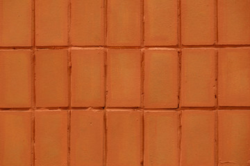 Wall of red tiles close-up. Abstract background. Geometric pattern