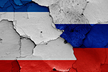 flags of Crimea and Russia painted on cracked wall