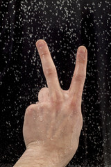 Arm showing peace symbol covered in water