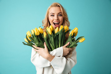 Portrait of a joyful young blonde woman in sweater