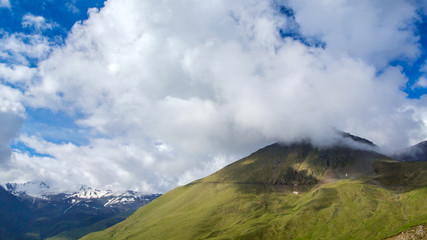 Mountain landscape and rain clouds among the snow-capped peaks