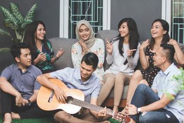 young happy friends singing together
