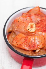 raw meat with sauce and garlic on pot