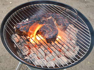 A grilled rib of beef on a barbecue