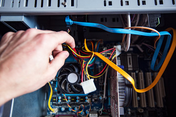 Man fixing an old desktop computer
