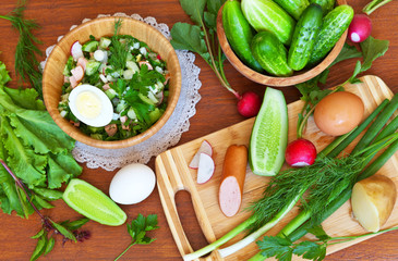 Preparation of home vegetable summer Olivier salad from fresh greens, cucumbers, radishes, potatoes and eggs. Healthy food. Traditional Russian cuisine