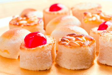 macro approach shot of marzipans in golden tray