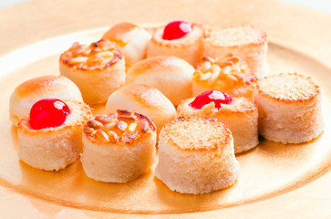 macro approach shot of marzipans in golden tray