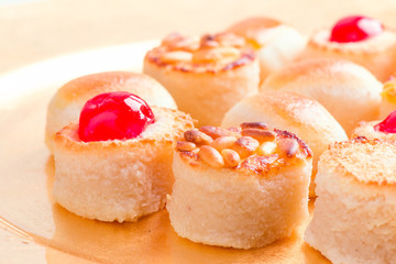 macro approach shot of marzipans in golden tray