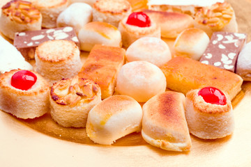 macro approach shot of marzipans in golden tray