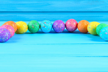 Colorful easter egg on blue pastel color wood background with space