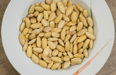 peel scuff skin almond nuts in plate 
