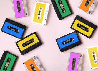 Retro cassette tape collection on pink background, top view
