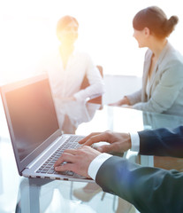 closeup of businessman typing on laptop.