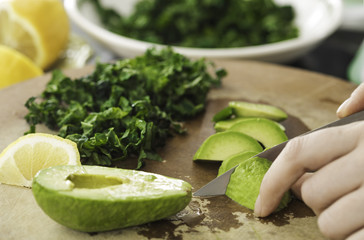 Closeup of woman's hands cooking vegetables salad in the kitchen