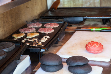portions of beef meat grilling on stove