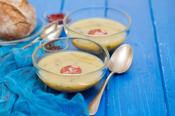 soup with spinach and smoked sausage in small bowls