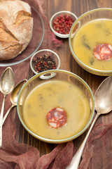 soup with spinach and smoked sausage in small bowls