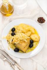 fried cod fish with onion and potato on white plate