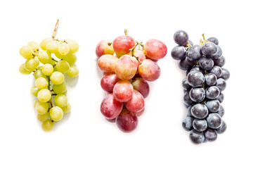 Red green and dark blue bunches of grapes isolated on white background