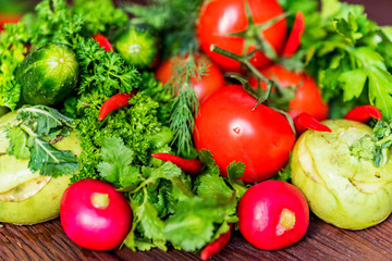Fresh vegetables and herbs on wooden table