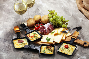 Delicious traditional Swiss melted raclette cheese on diced boiled or baked potato.