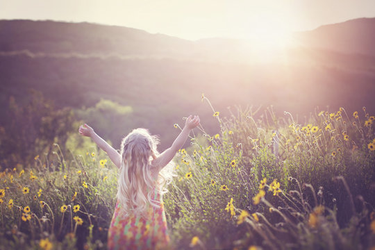 Rear View Of Girl Standing In Field