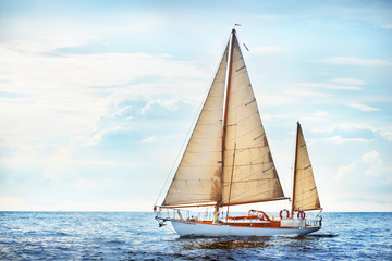 Old expensive vintage two-masted sailboat (yawl) close-up, sailing in an open sea. Coast of Maine, US. Sport, cruise, tourism, recreation, leisure activity, transportation, nautical vessel	