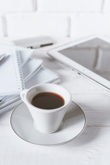 Stylish workspace with notebook, cup of coffee, paper blank, pencils. Business concept. Flat lay, top view.